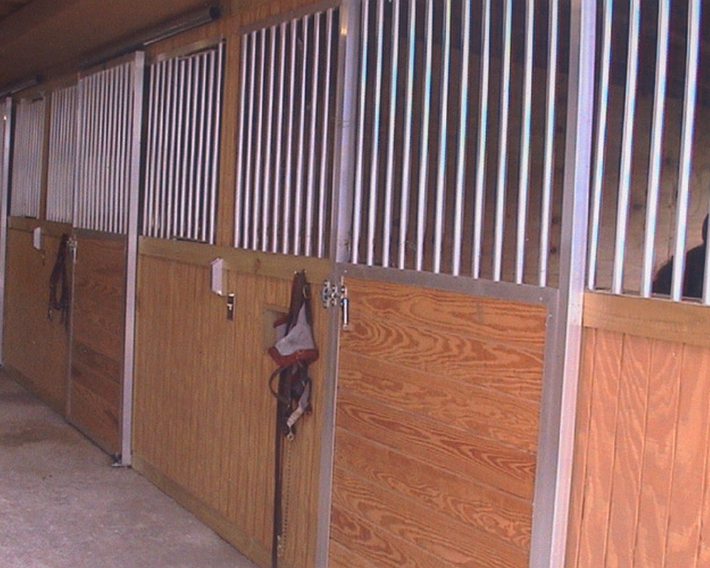 Tongue and groove sliding horse stall doors.
