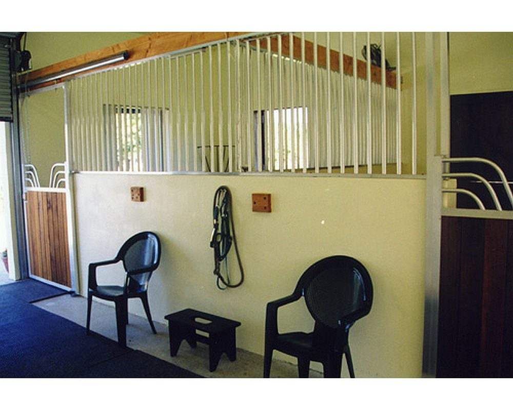 Ventilated horse stalls with stall divider grills.