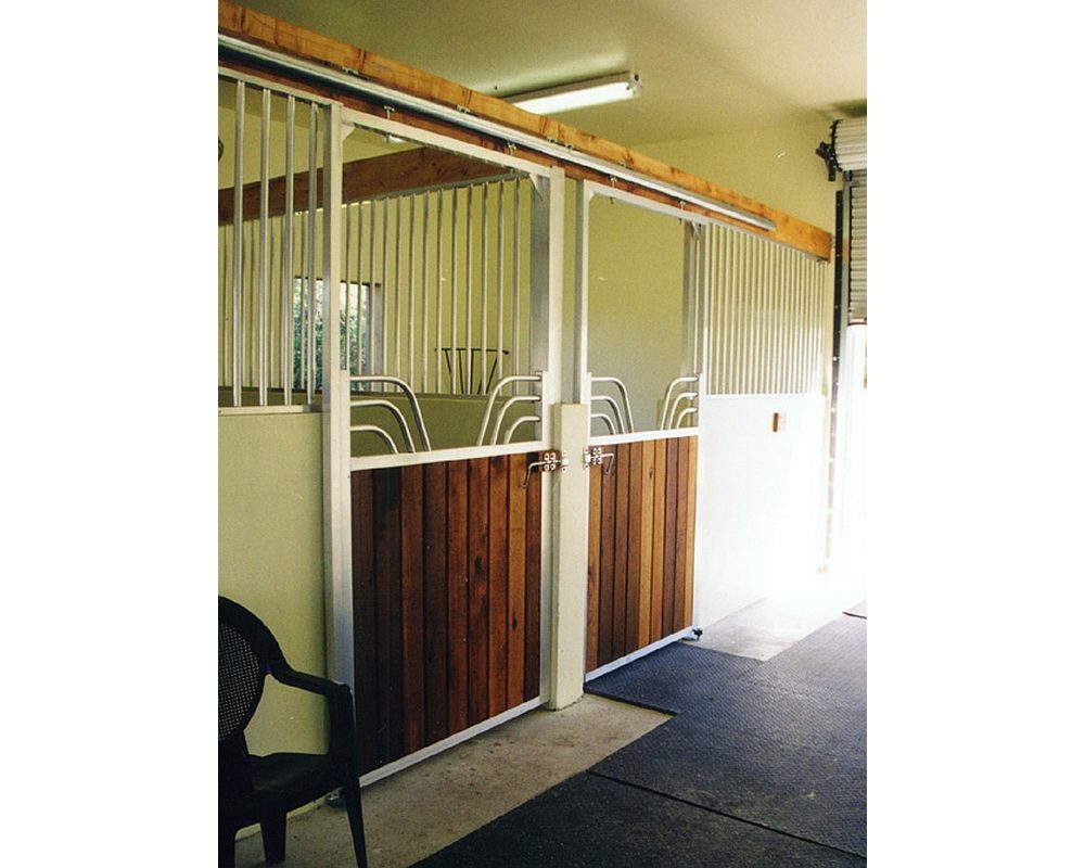 Gossip top sliding horse stall door with vertical tongue and groove lumber.