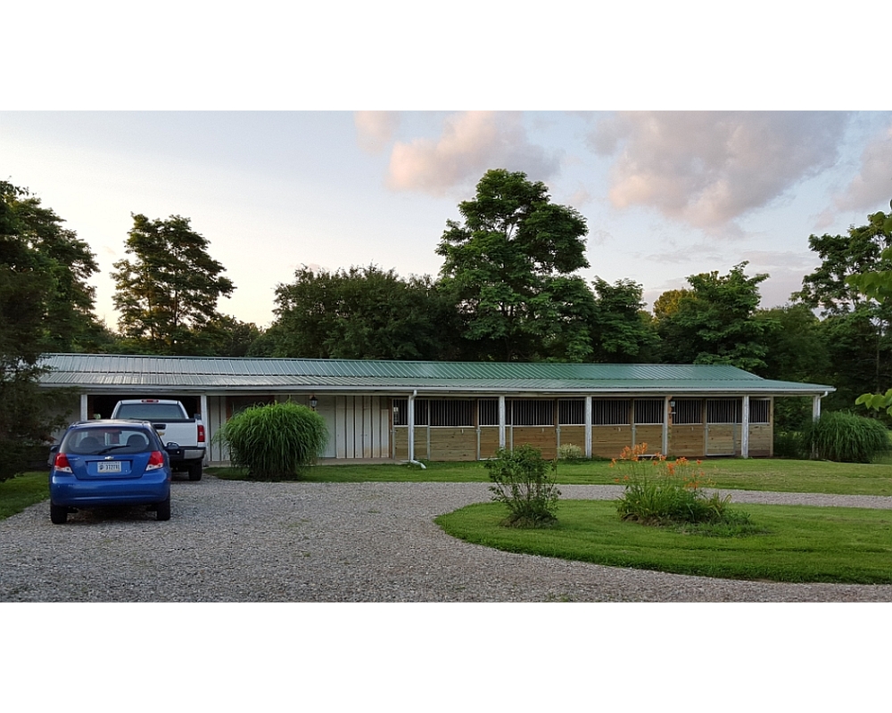 Borneman horse stables, sliding stall doors and aluminum grills.