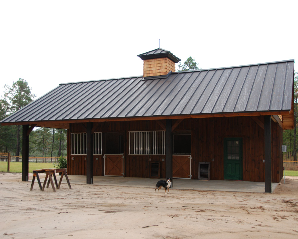 Crossbuck half gates on exterior of horse barn.