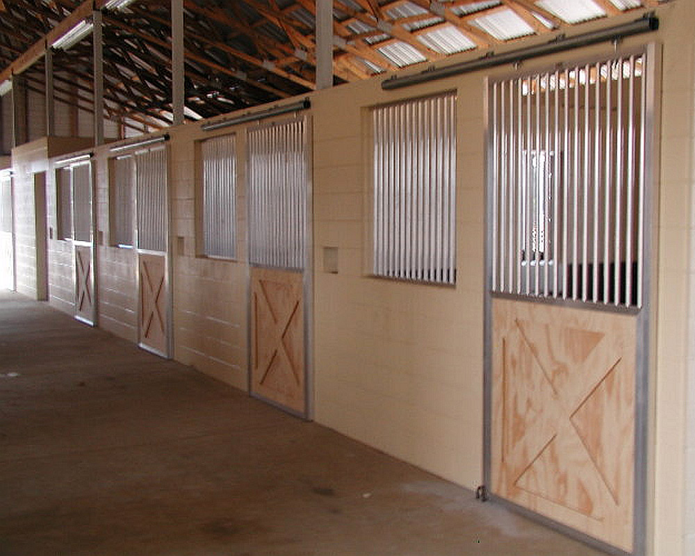 Crossbuck sliding stall doors with 2" between bar spacing.