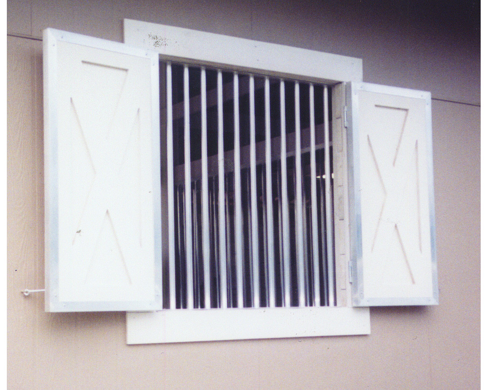Double swing hinged crossbuck barn shutters.