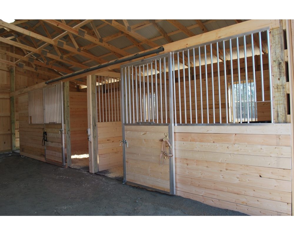 Sliding horse stall doors with fold down panels.