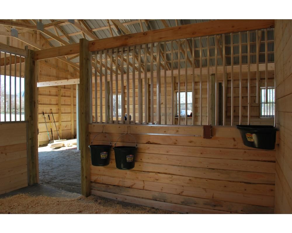 Cogliati horse stable with aluminum horse stall components.