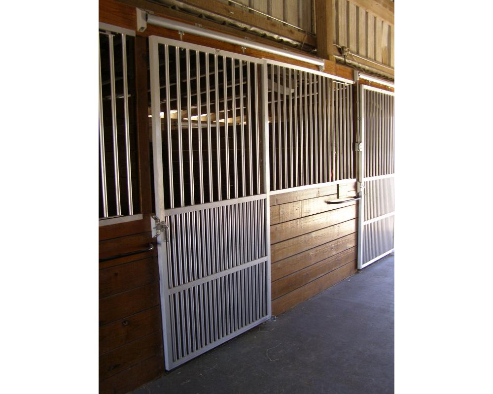 Ventilated horse stall fronts featuring coolbreeze sliding doors.