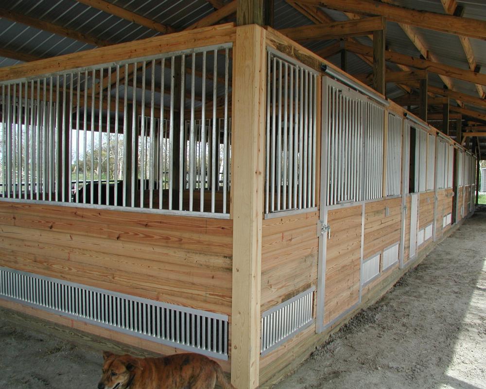 Horse stalls with vent a grill panels.