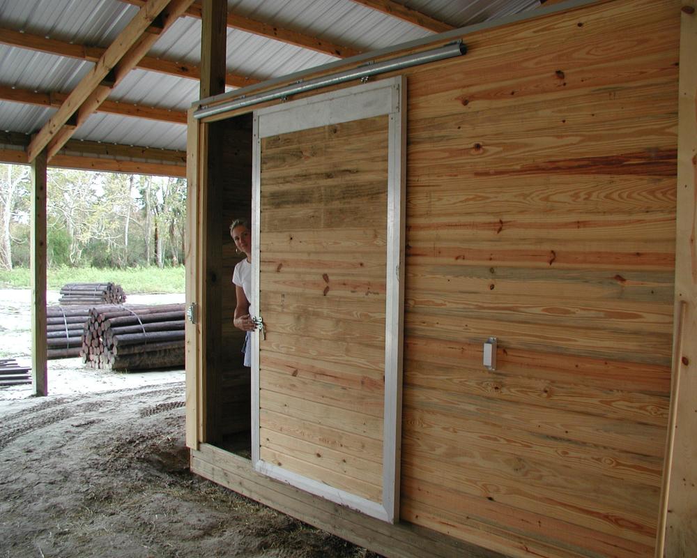 Single panel end barn door used for tack and feed room.