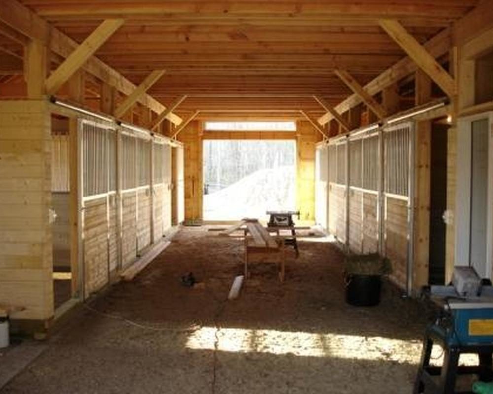 Harney horse barn featuring aluminum sliding stall doors and grills.
