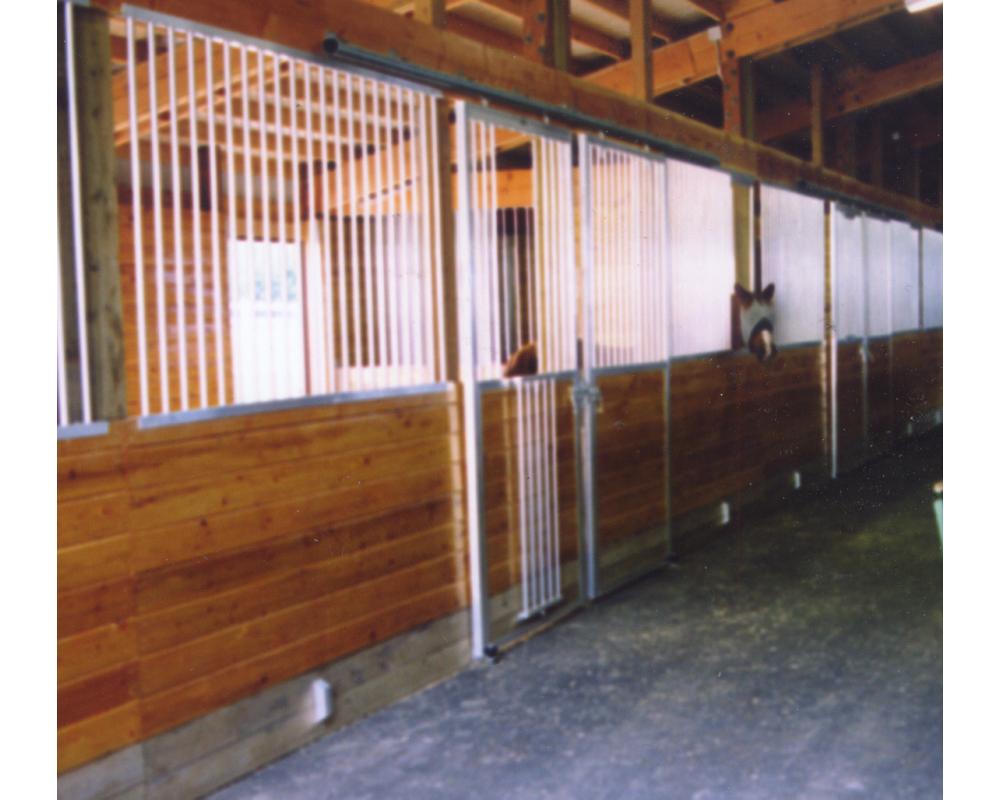 Sliding horse stall door with spring loaded fold down panel.