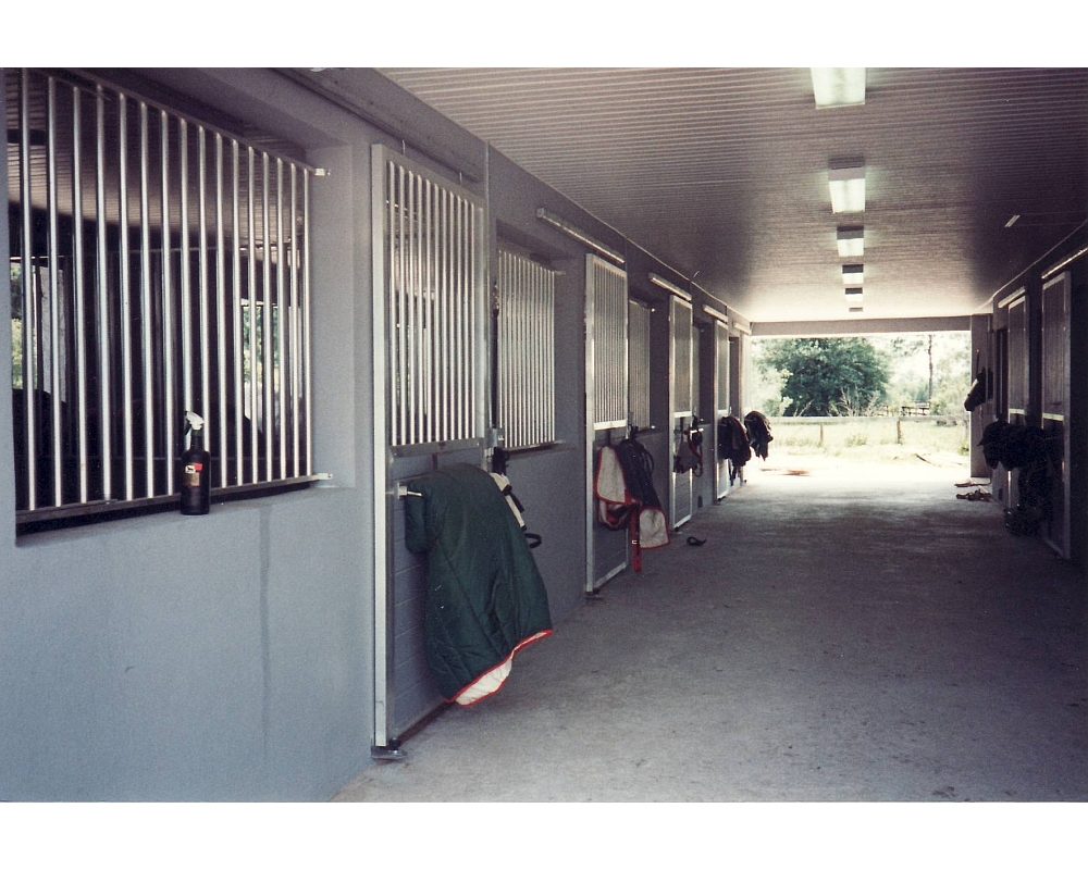 Horse stall fronts with tongue and groove sliding doors.