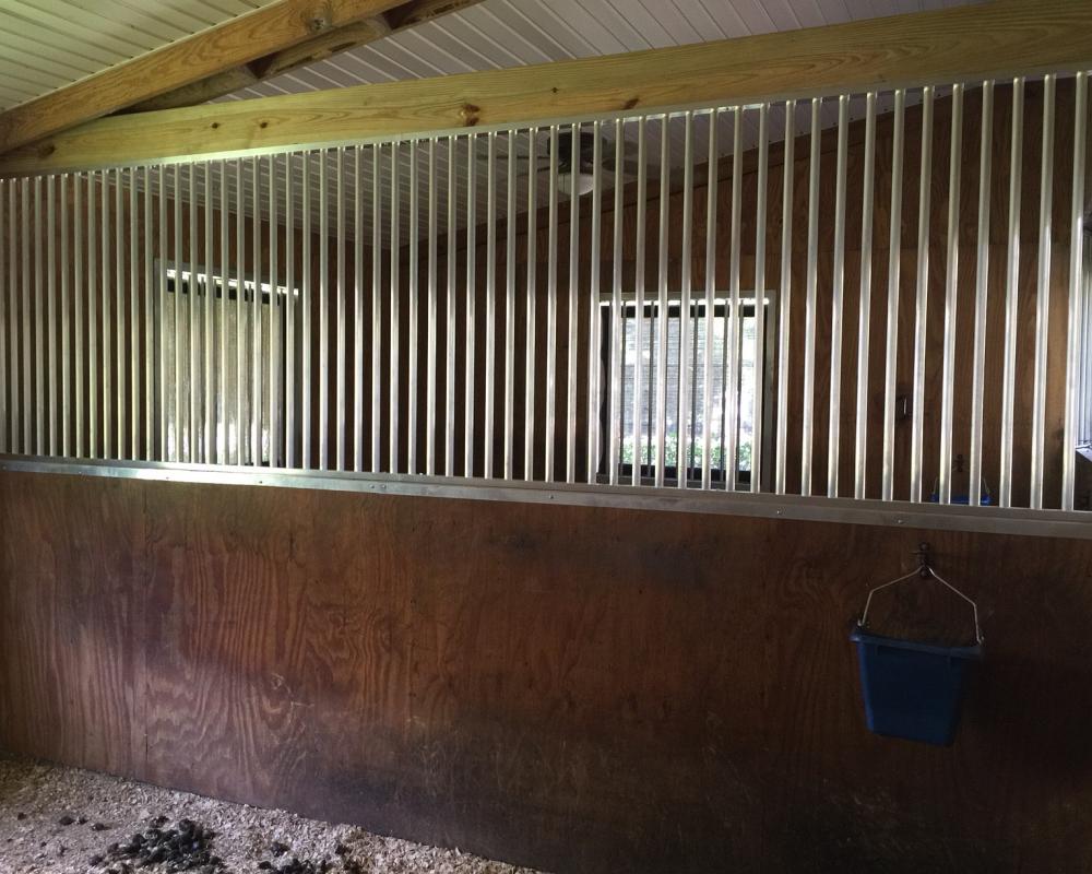 Lance barn after renovation with new aluminum stall grill partition.