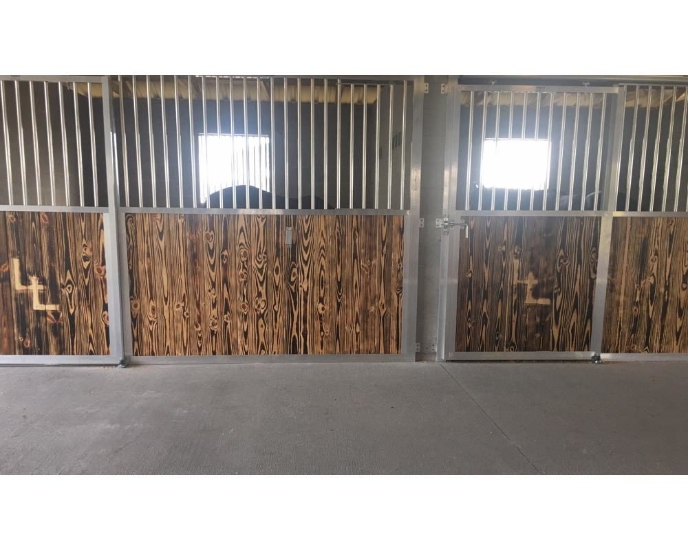 A traditional horse stall panel system that can bolt between existing posts.