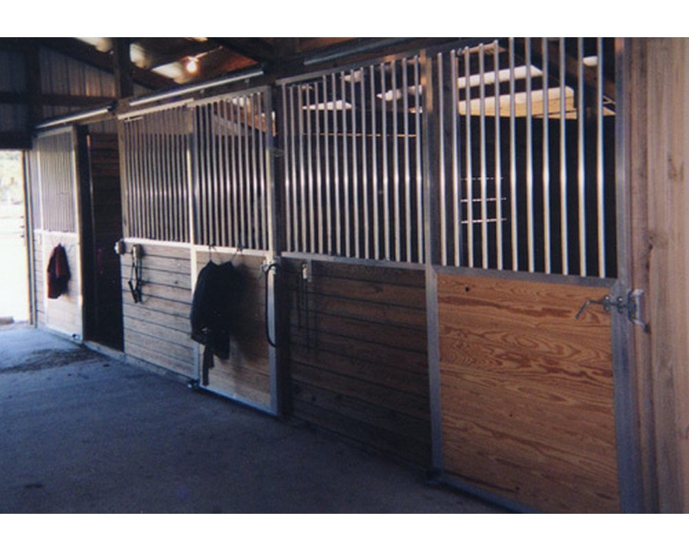 Horse stall front with aluminum no rust grills and sliding doors.
