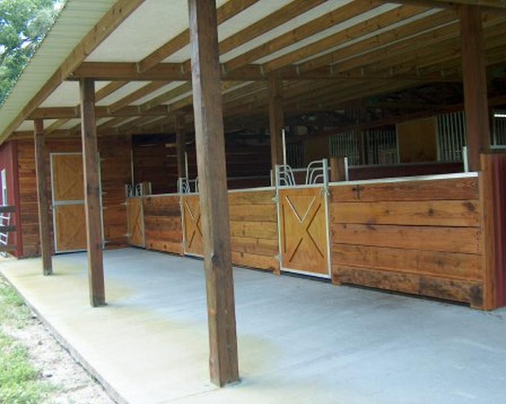 Horse stall crossbuck gates with gossip tops.