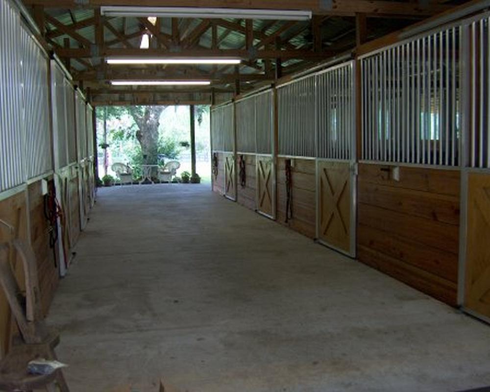 Horse stall fronts with aluminum no rust grills and sliding doors.