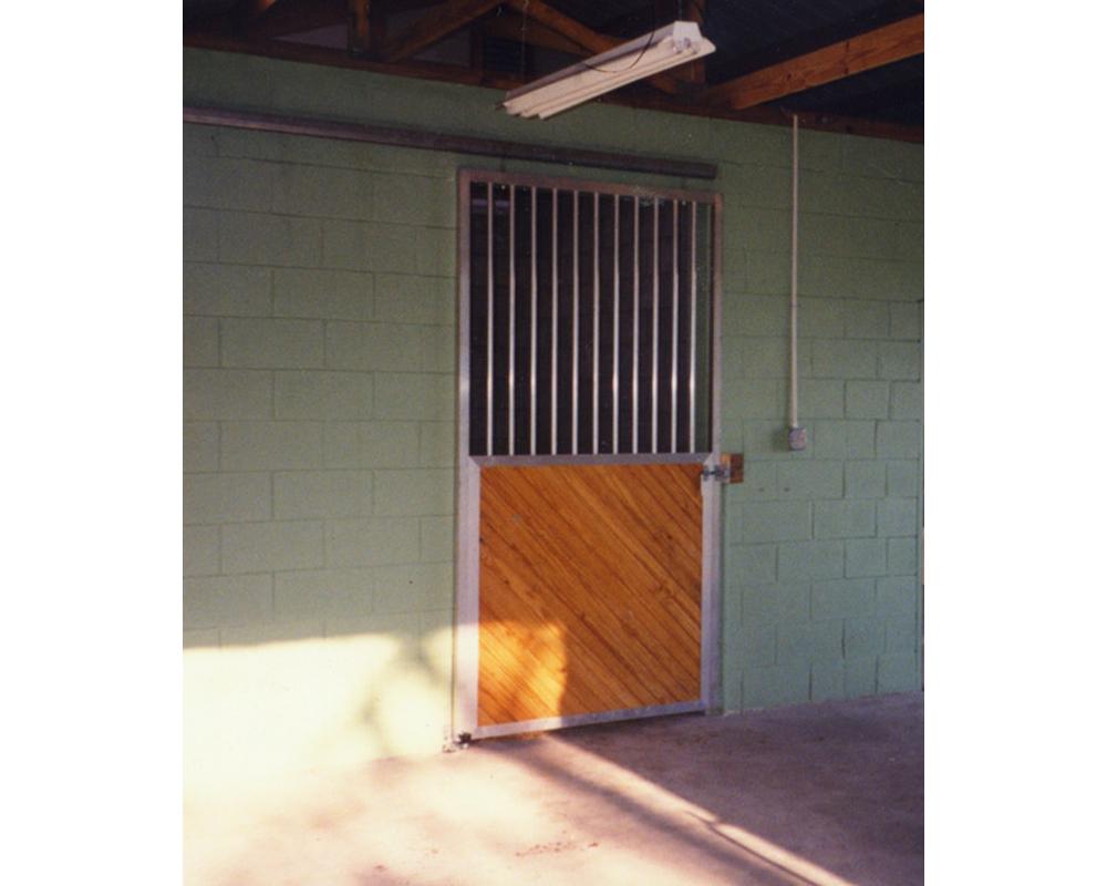 Custom horse stall door with diagonal lumber.