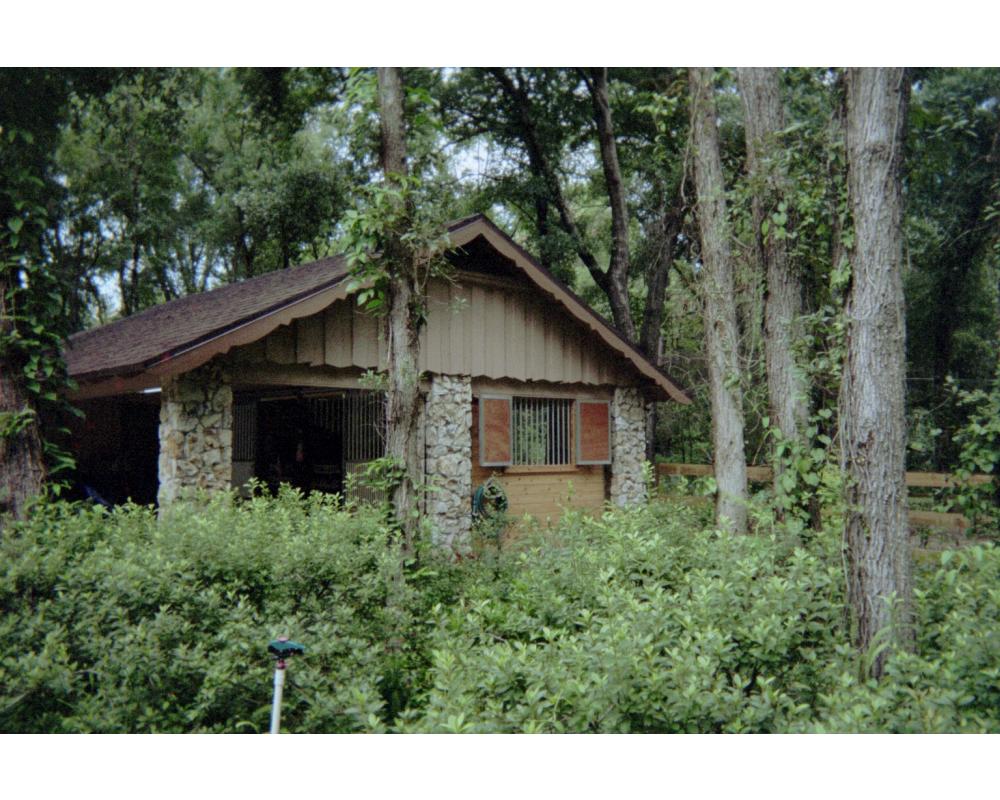 Barn exterior with double swing window shutters.