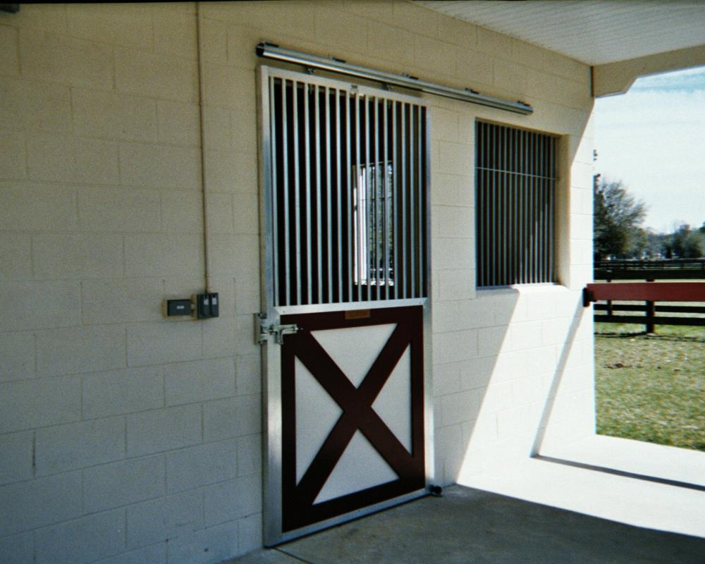 Crossbuck sliding stall door with 2" between bar spacing.