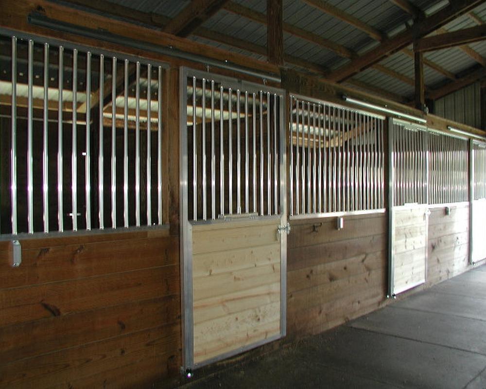 Sliding horse stall doors and aluminum grills.