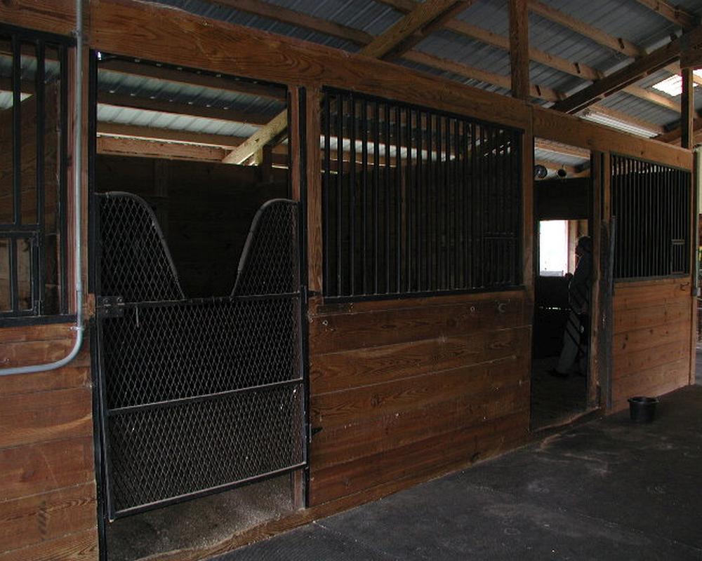 Rusty old iron horse stalls before switching to Aluminum no rust horse stalls.