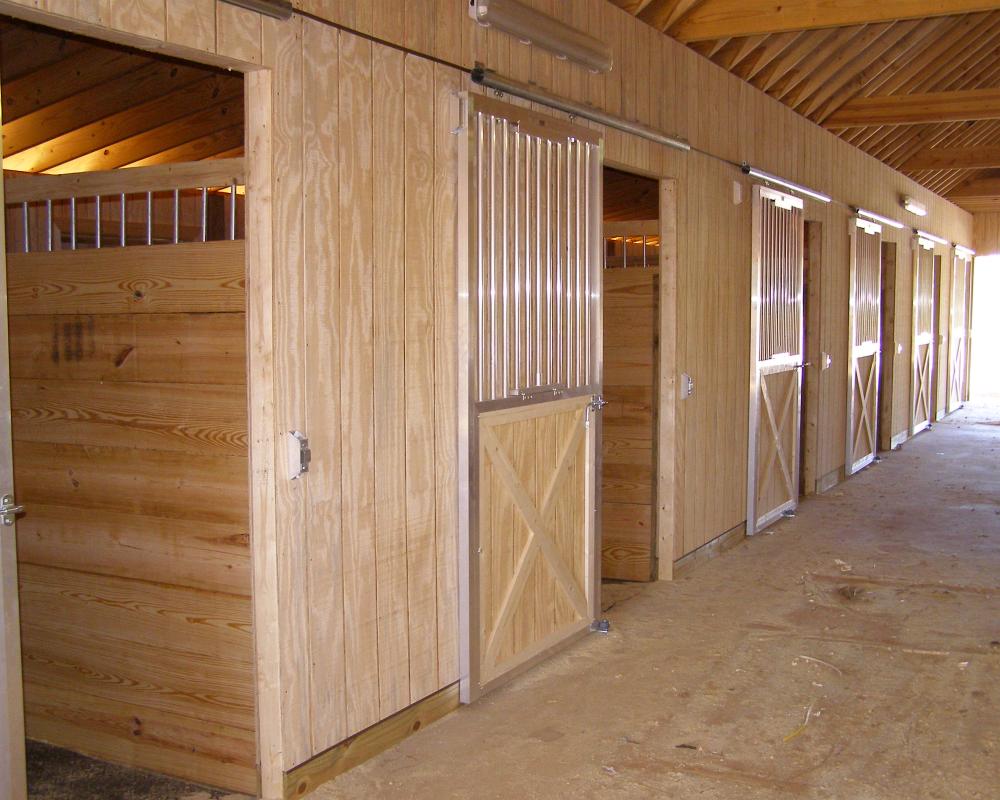 Aluminum sliding horse stall door with fold down panel.