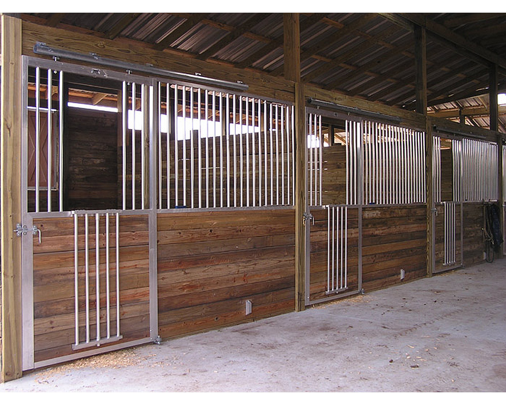 Sliding horse stall doors with fold down panels.