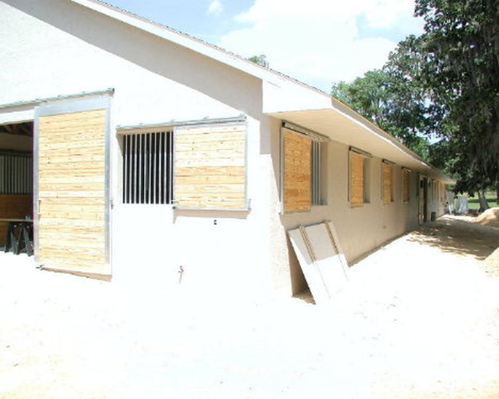 Sliding tongue and groove horse barn shutters.