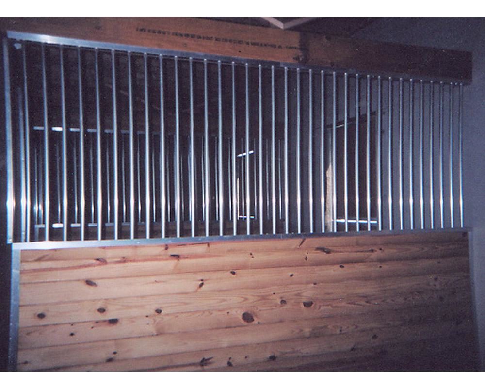 Aluminum stall grill partitions in barn.