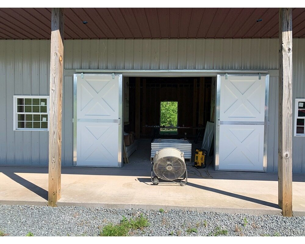 Sliding end barn doors, endura material, crossbuck fascia.