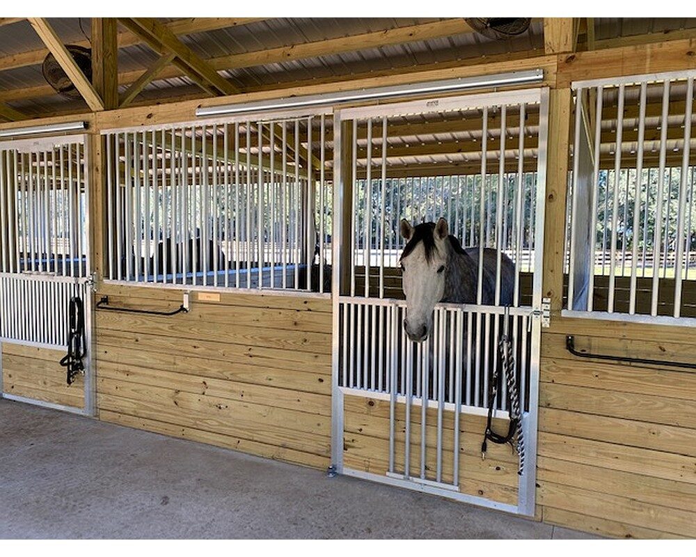 Fold down panel tops in Armour's sliding doors allows for horses to look out into the aisleways.