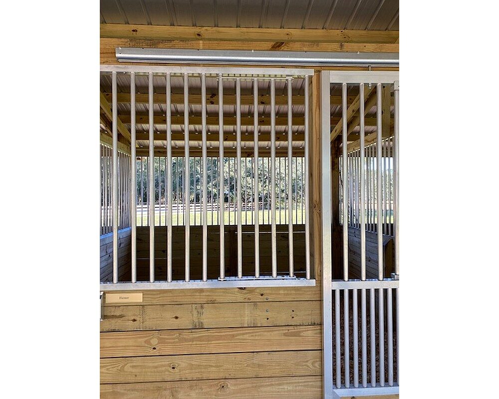 Feeder access door in stall front grill in closed position.