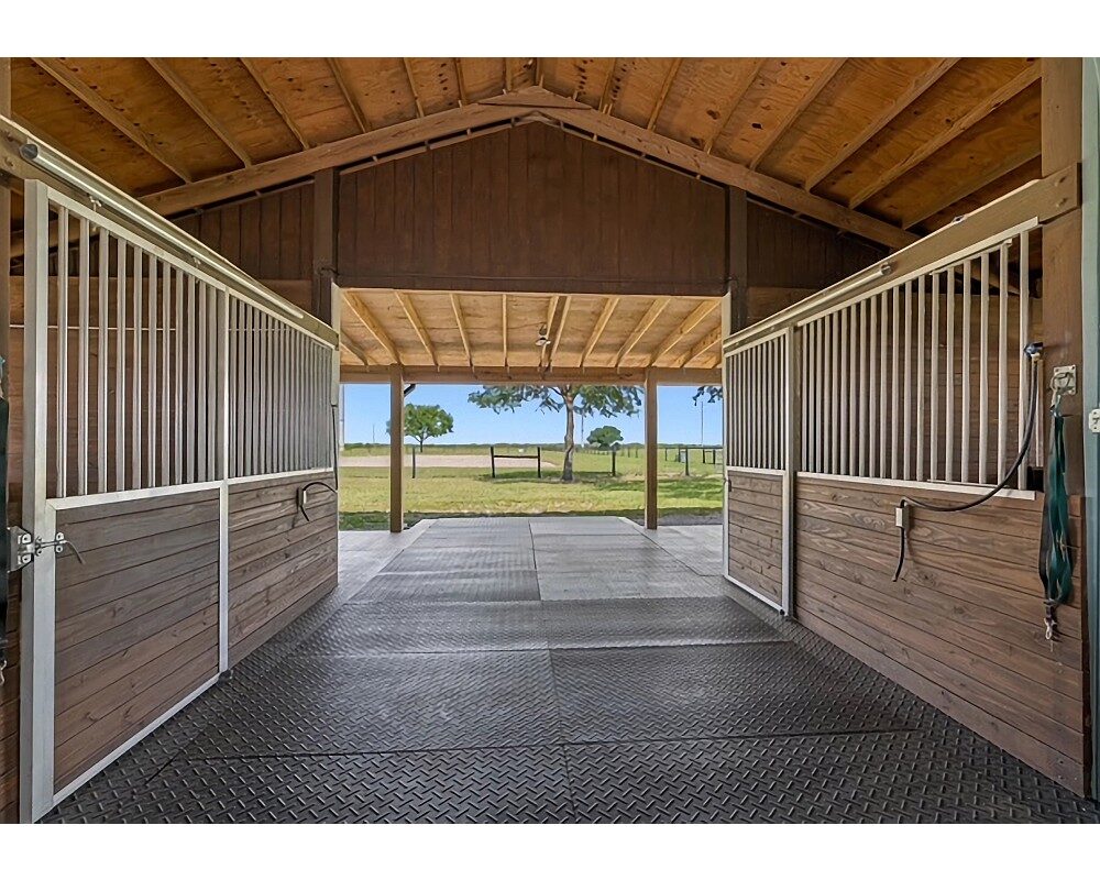 Aisle view of Armour Horse Stalls products installed in Myakka Oaks Ranch.